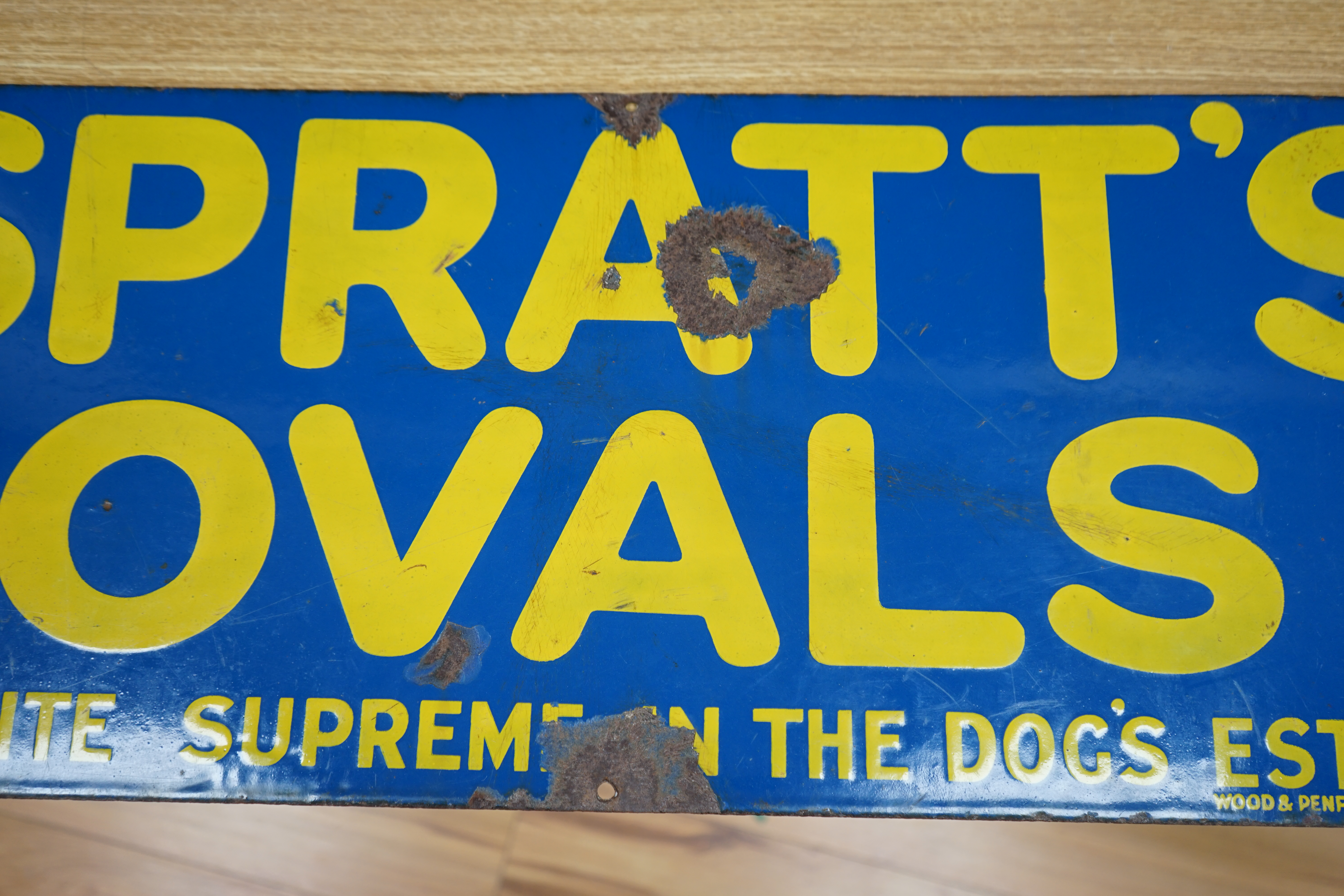 An advertising enamel sign, Spratts Ovals are quite the Supreme in the Dog's Esteem, Wood & Penfold Ltd., 30.5 x 76cm. Condition - poor to fair, several losses as photographed